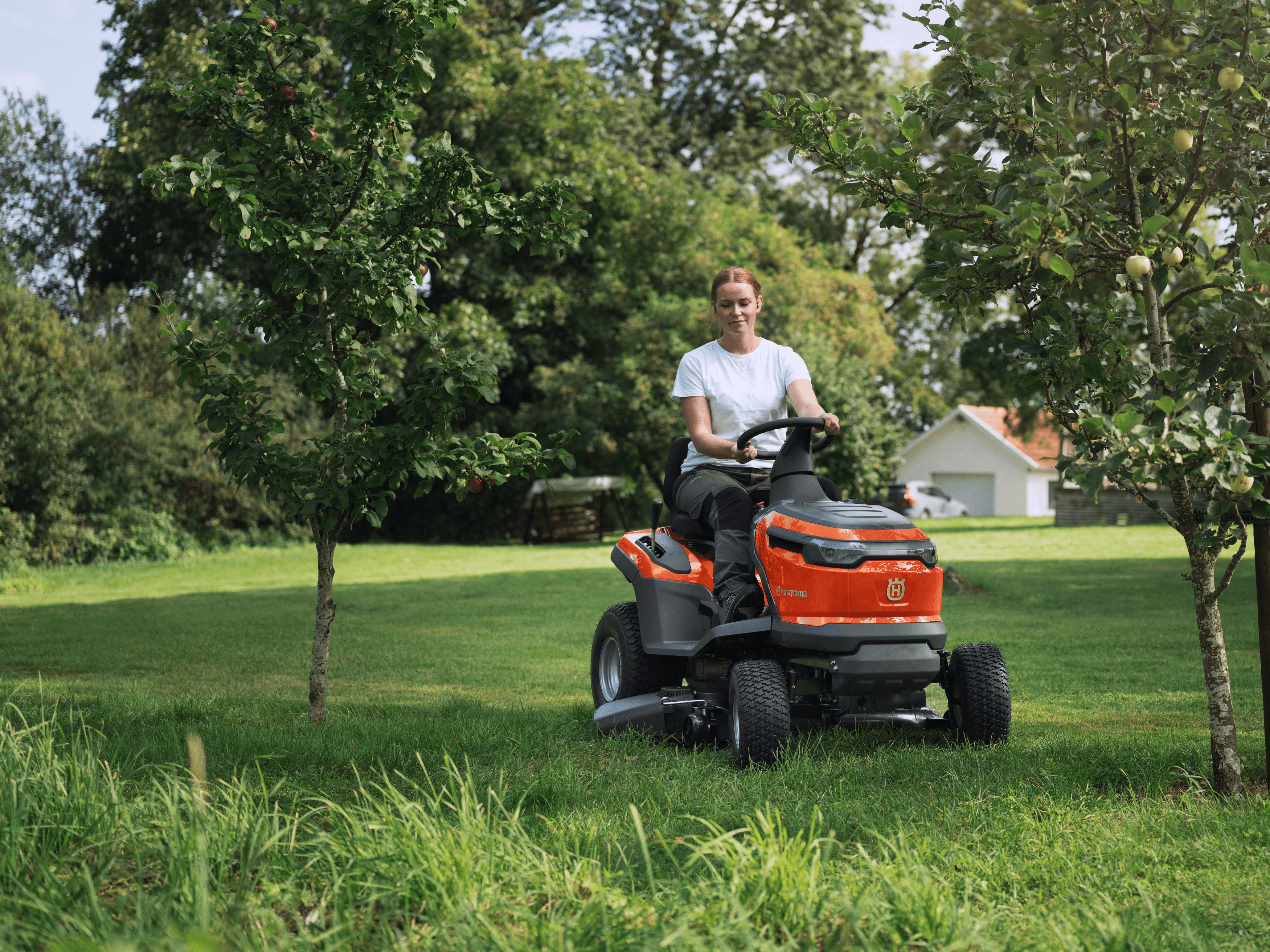 man holding polesaw whilst cutting tree